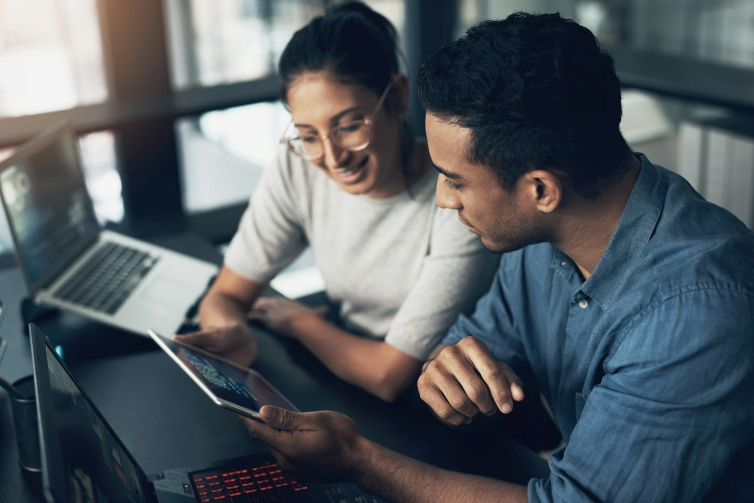 shot of two young workers using a digital tablet in a modern office 1536x1025 1